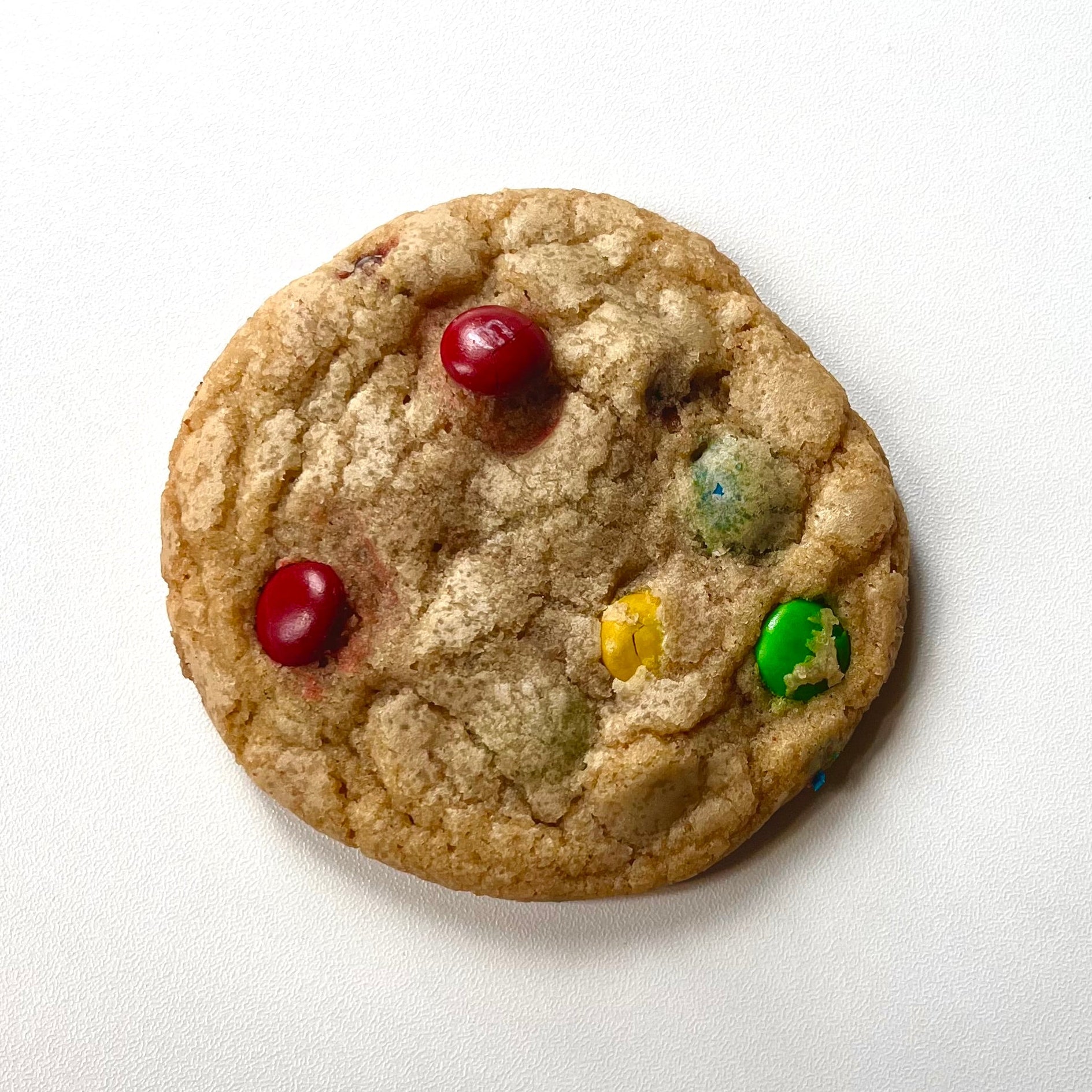 Cookie with M&Ms on a white background
