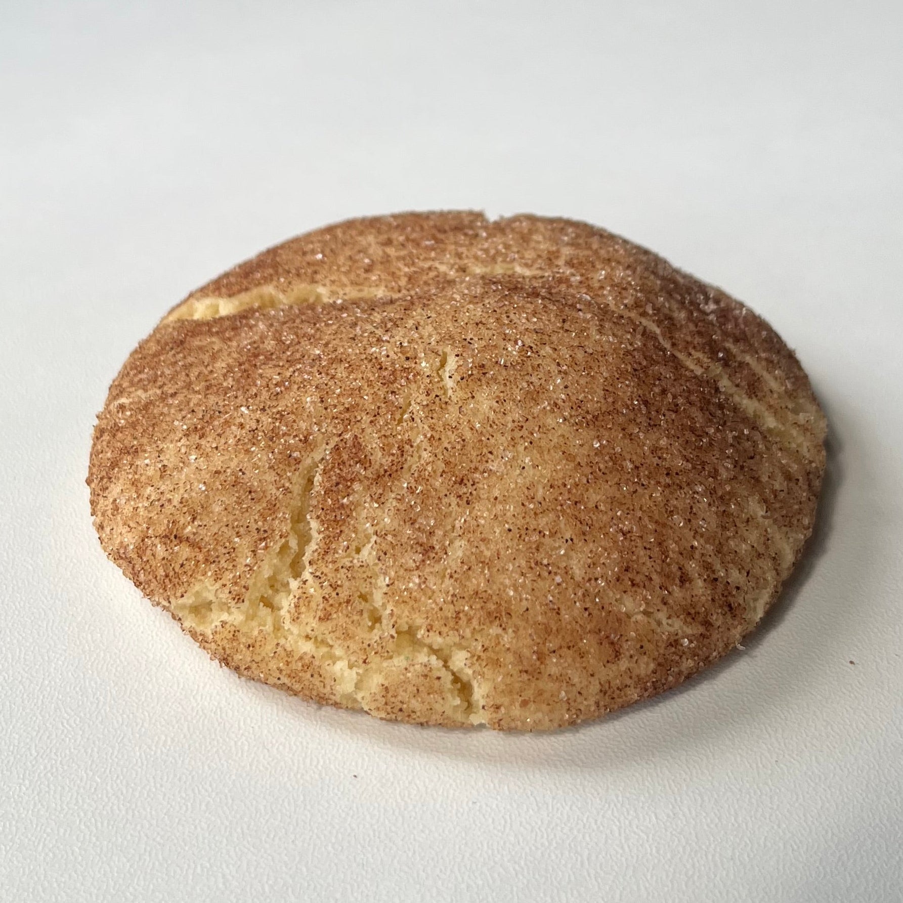 Snickerdoodle cookie on a white surface
