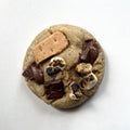 Cookie with chocolate chips, marshmallows, and a graham cracker on a white background